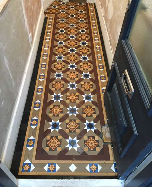 Clean and shiny Victorian geometric tiled floor of a London home