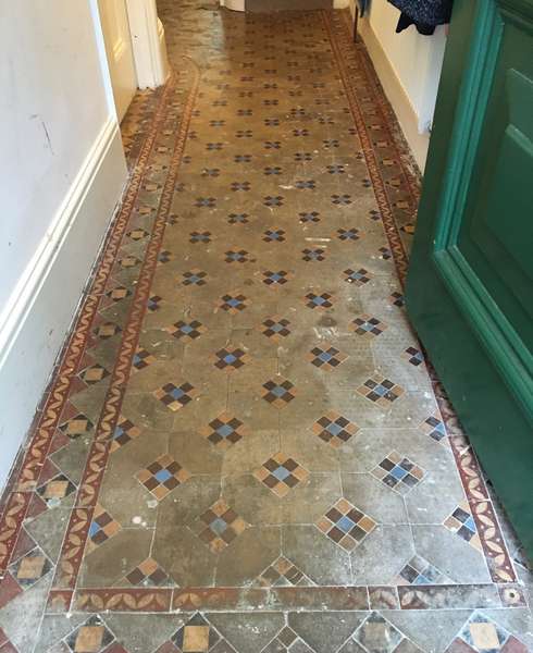 Dirty Victorian tiled floor in London home hallway