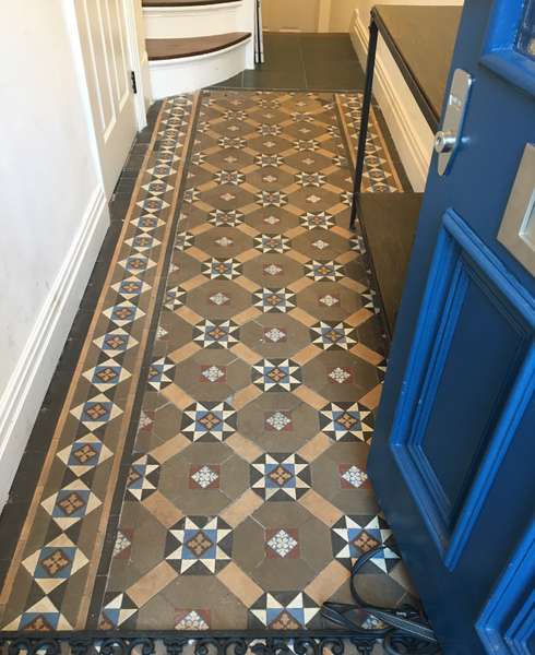 Downstairs hallway of a house with a Victorian or Edwardian tiled mosaic floor